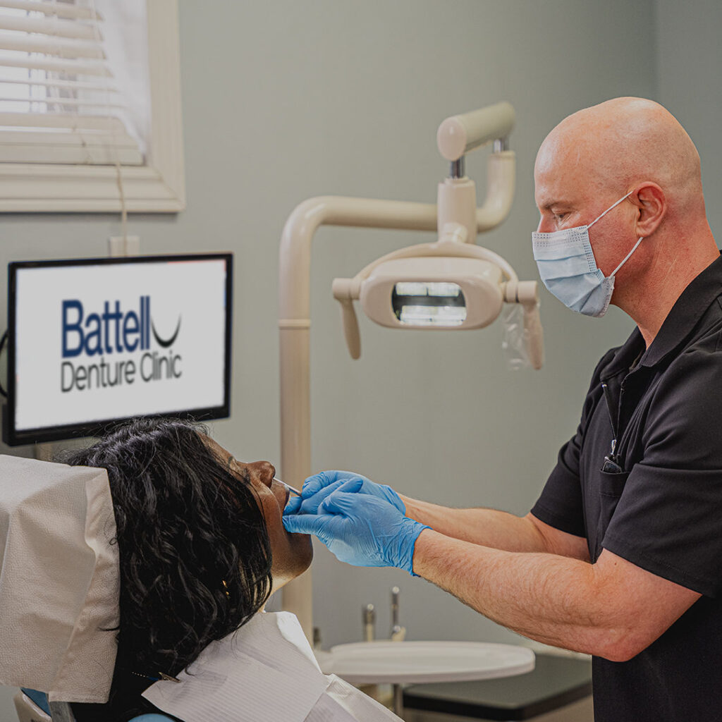 Helping a denturist customer with dentures